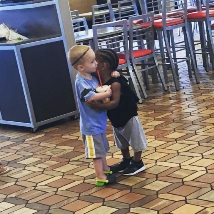 "These two children hug each other, even though they do not know each other."