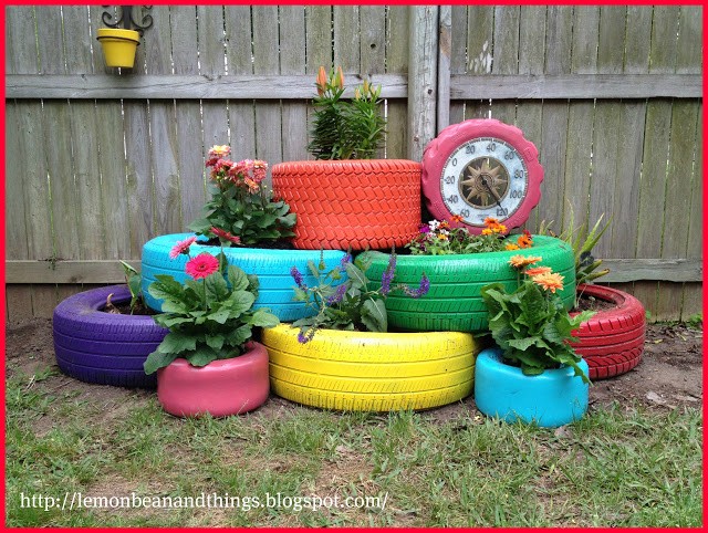 7. Old tires become a garden oasis of colorful planters and vases!