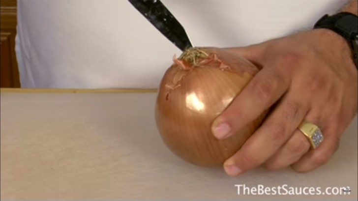 According to the chef, it is the central part that causes tearing. Therefore, it must be eliminated by cutting the onion with the knife slightly angled on the end with the roots.