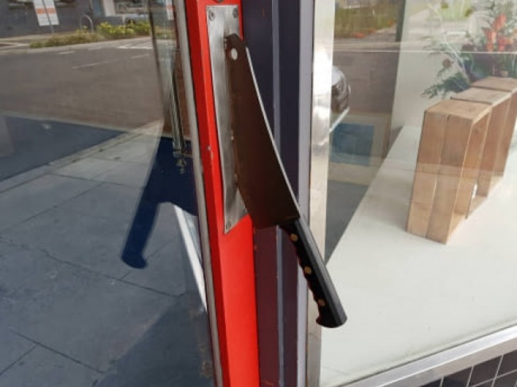 The handle of this butcher shop door.