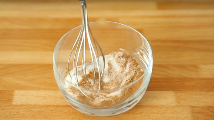 7. Dans un bol, ajoutez deux cuillères à soupe de sucre, de la cannelle en poudre et une pincée de muscade. Saupoudrez les biscuits farcis aux pommes avec ce mélange et faites cuire au four à 180° pendant environ 15 minutes.