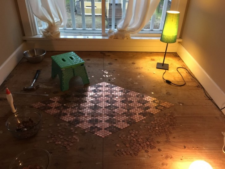 Tonya applied the coins to the floor with Elmer's glue, starting by creating a perfect square in the middle of the room.