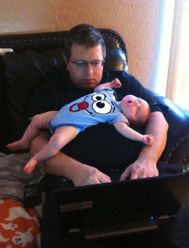  3. This dad has work to do but his son prefers to sleep!