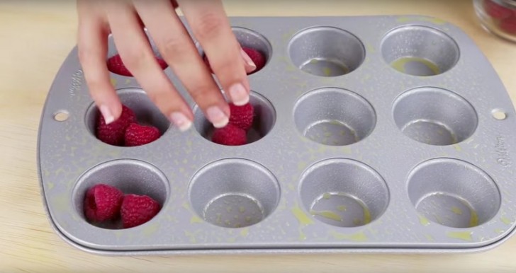 5. Place the raspberries in the muffin pan molds.