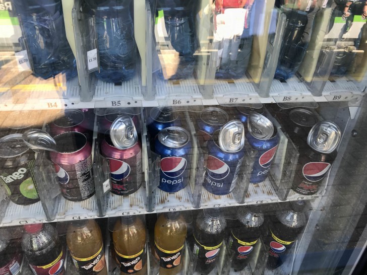 A heat wave caused the soda cans in this vending machine to explode!