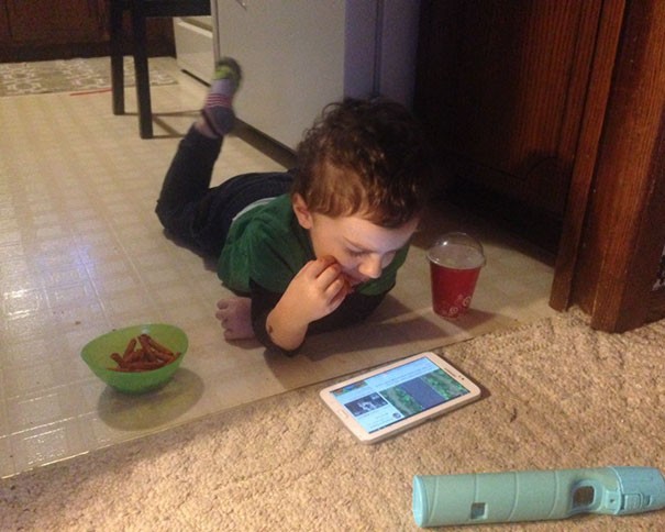 4. His mother told him that he could not eat in the living room and that he could not use his tablet in the kitchen. He has managed to position himself in such a way as to follow both rules!