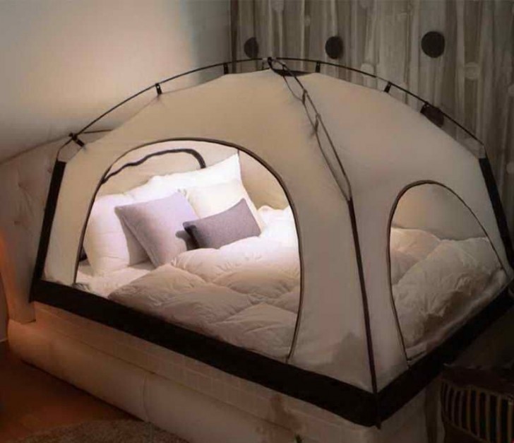 16. A camper tent mounted on your bed immediately creates an intimate and adventurous atmosphere!