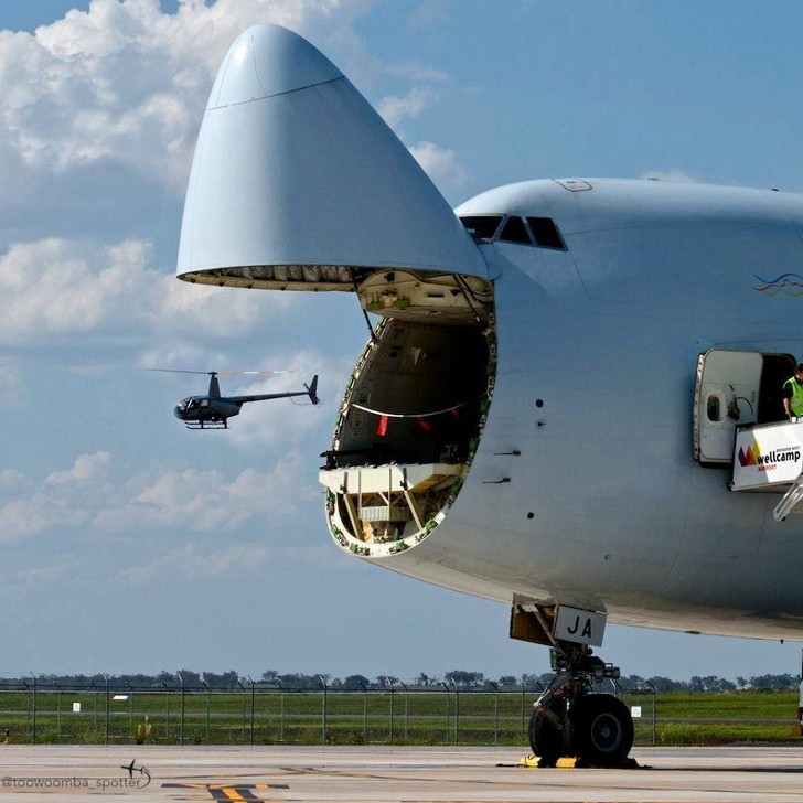 This aircraft cargo hold appears to be about to "eat" the helicopter!