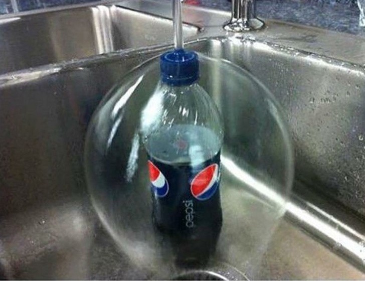 The water flows over and around the bottle cap and creates a kind of "bubble".