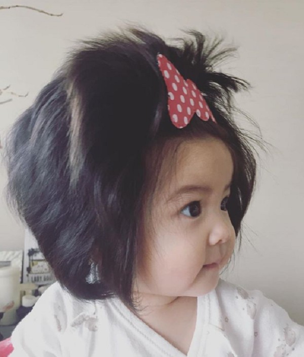 In every photo, Chanco has a new hairstyle or hair accessories, like this polka dot bow.