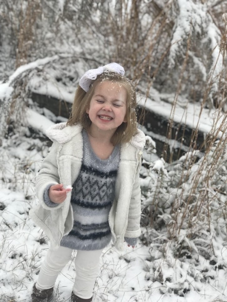 13. It is the first time this child has seen snow and she seems to be in seventh heaven!