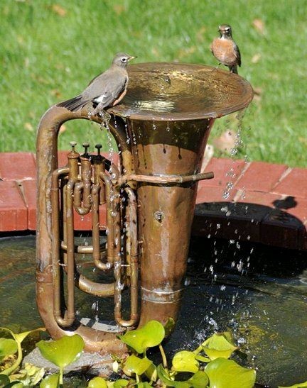 7. A musical instrument like an old tuba can have a second life as a water fountain --- and as a watering hole for thirsty birds!