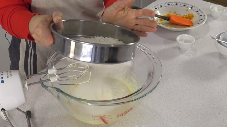 Next, sift the baking powder together with the flour and add it to the rest of the ingredients combining the ingredients with an electric mixer.