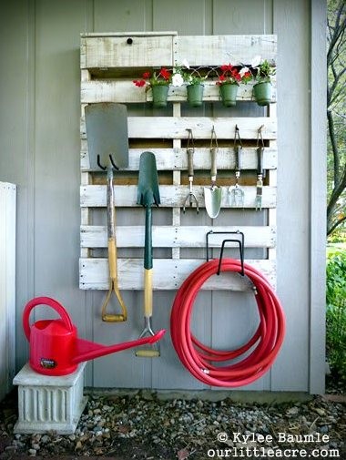 1. A wooden pallet can become a multi-purpose tool rack for organizing tools and other objects.