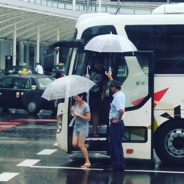 17. Le conducteur du bus garde son parapluie ouvert pour que les passagers aient le temps d'ouvrir le leur.