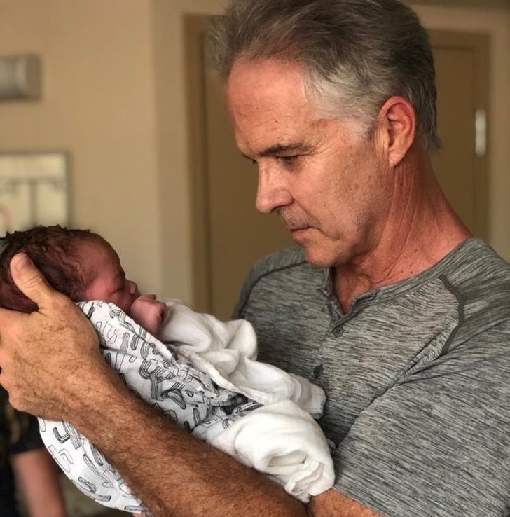 22. Momenti indimenticabili che vanno immortalati: un nonno tiene in braccio il suo nipotino per la prima volta...