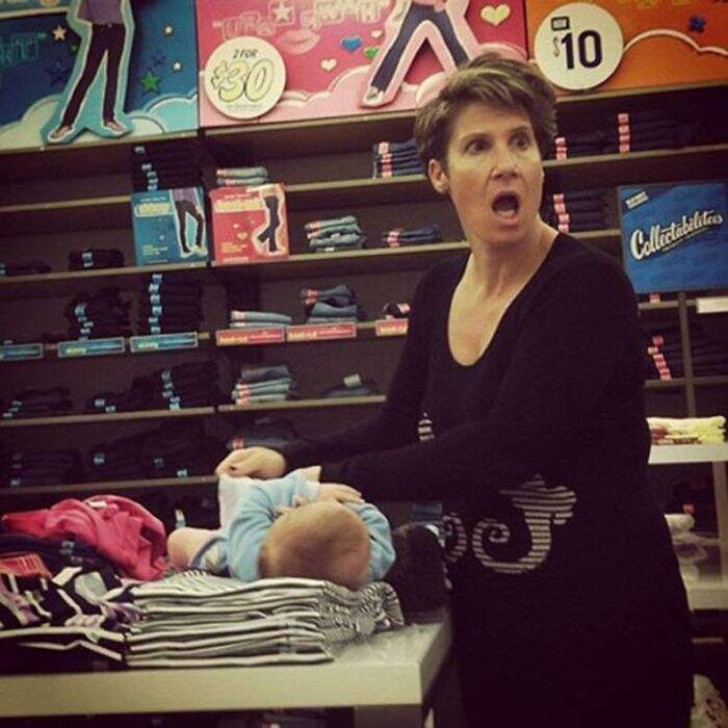 4. An undisturbed mother changes her baby's diaper on top of clothes for sale in a store. And she is also surprised and angry because the sales staff are taking a picture of her!