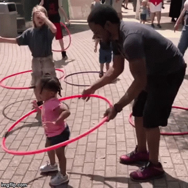 His daughter's first hula hoop attempt!