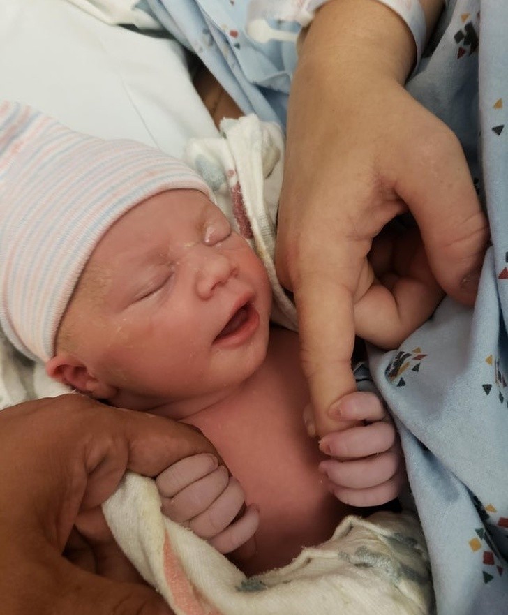 The first physical contact between a newborn baby girl and her mother's finger ...