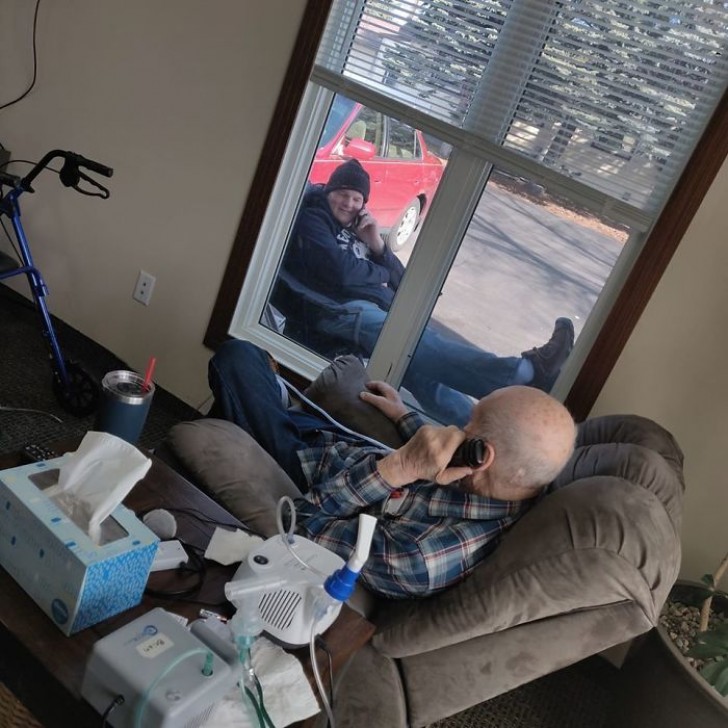 This man's retirement home wouldn't let visitors in, so his son talked to him on the phone... while sitting outside his living room window