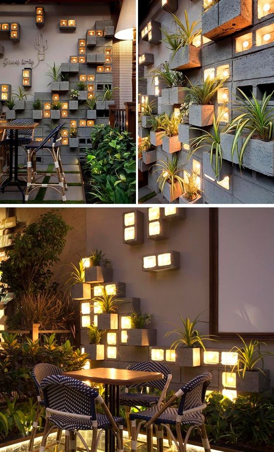 11. Una fantastica parete di cemento decorata con piante e luci