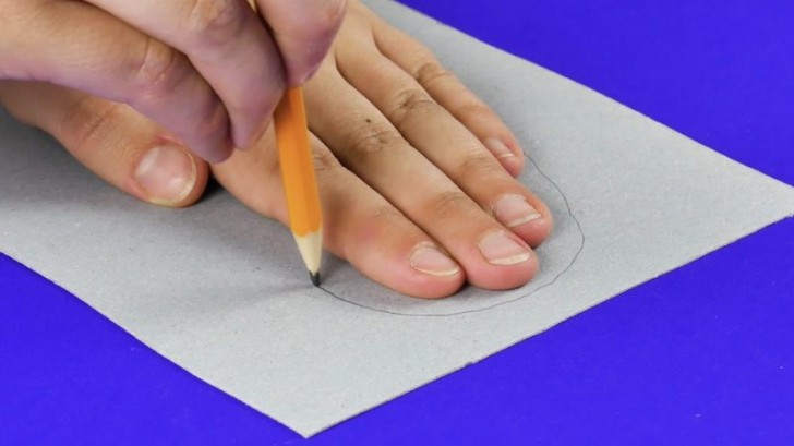1. Disegnate una sagoma tondeggiante sulla parte alta del cartone, un po' più ampia delle dimensioni della vostra mano (a dita chiuse)