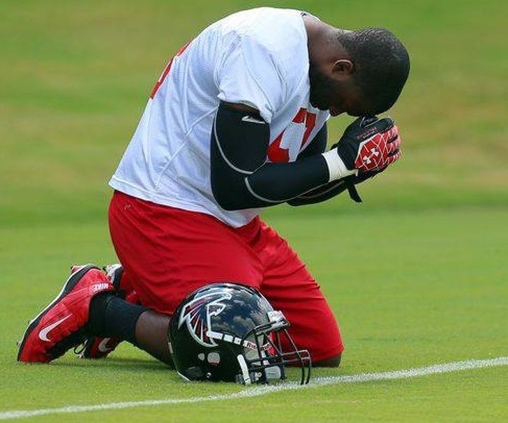 Brian Banks thanking God on the football field after discovering he was exonerated in a rape case from 11 years ago
