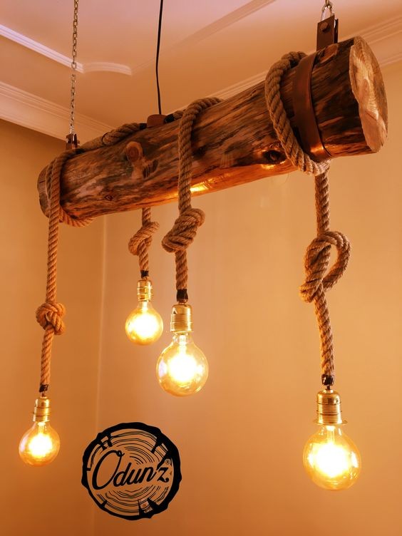 8. Portalampade fissati a corde intrecciati, a loro volta fissate a un tronco sospeso al soffitto: quando l'illuminazione sposa la creatività