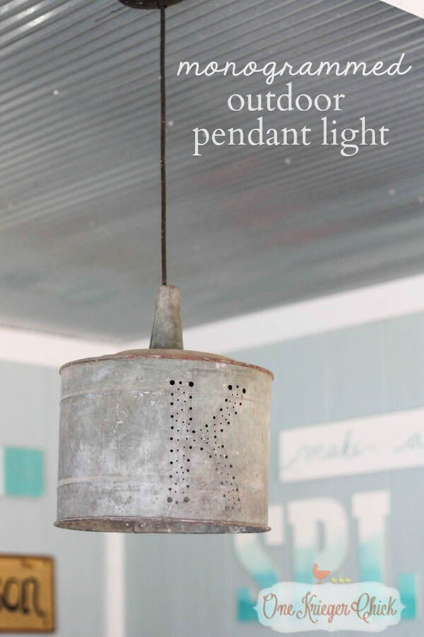 7. Een buitenlamp, versierd met een monogram gemaakt door een ijzeren emmer te perforeren