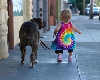 A little girl taking her furry friend for a walk!