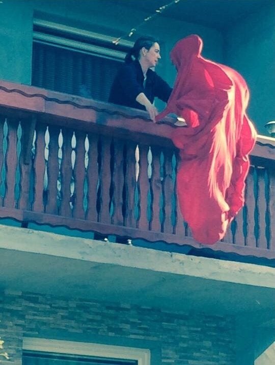 Is someone dressed in red climbing the balcony? No, it's just a sheet!