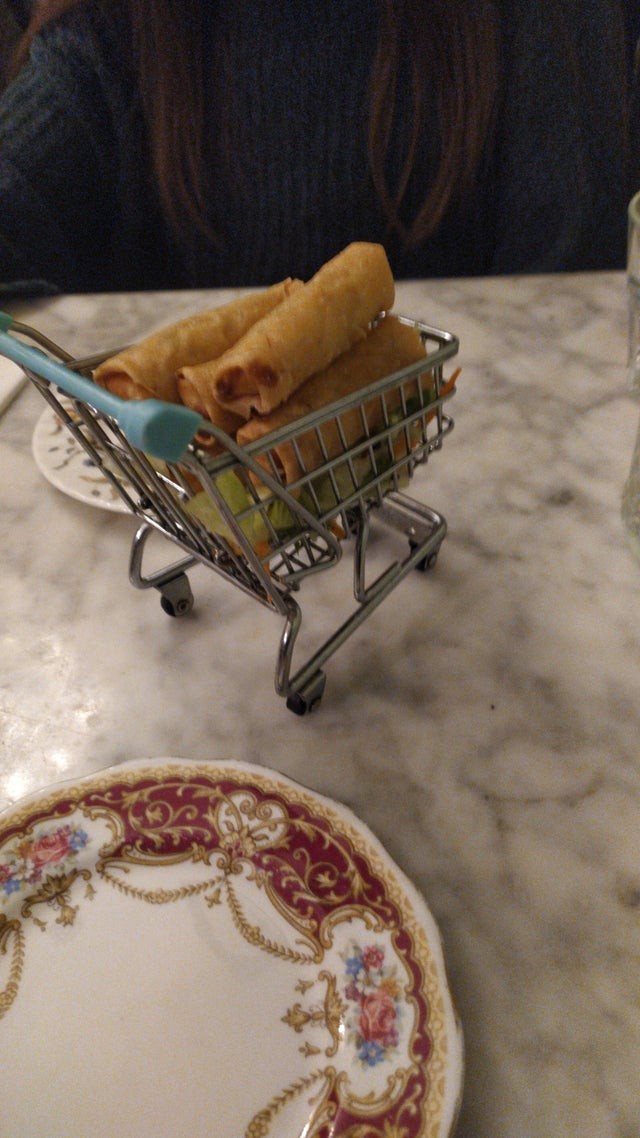7. Spring rolls served in a miniature shopping cart