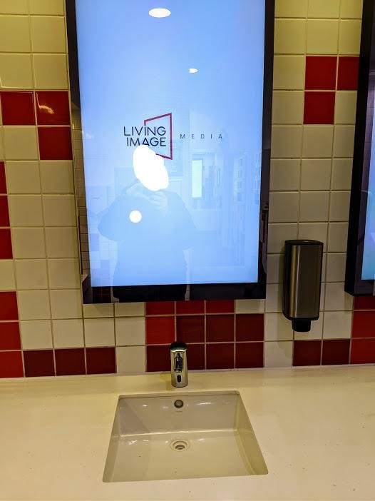 7. Waarom zou je een handige spiegel niet door een reclamescherm vervangen? Het absurde idee van dit winkelcentrum...