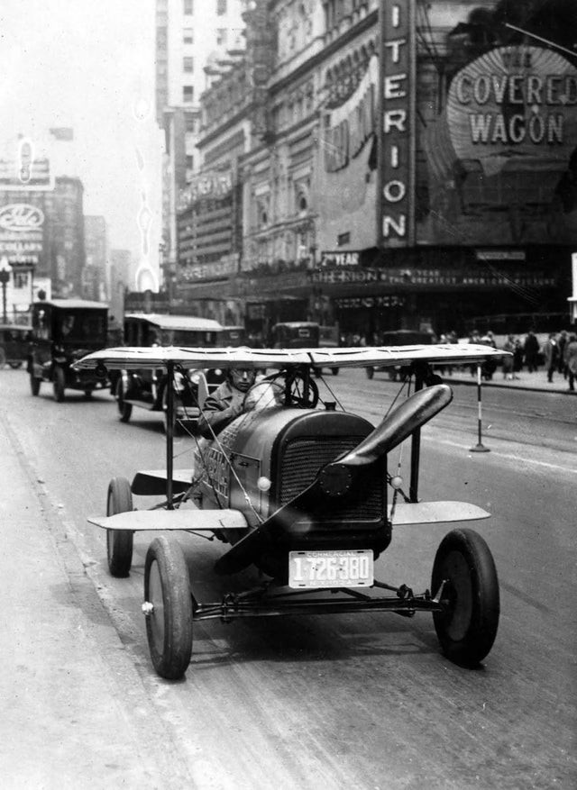 16. A. H. Russel, ein Mann aus New Jersey, während er am Steuer seiner neuen Erfindung sitzt: ein mit Flügeln und einem Propeller ausgestattetes Auto. Times Square, New York, etwa 1924
