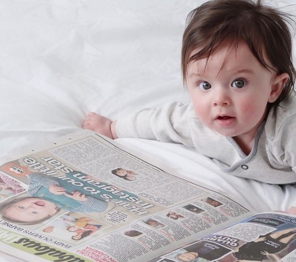 8. He is already so big, and not just for his soft, shiny brown hair: like a good little man he decided to read the newspaper.