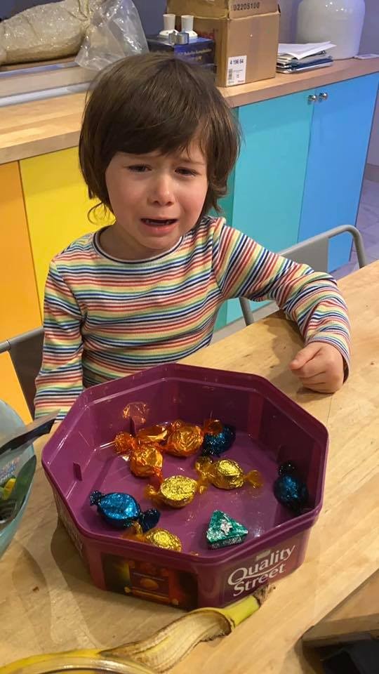 13. This kid's crying because he can't decide which candy to take from the bowl. Can't he have them all?