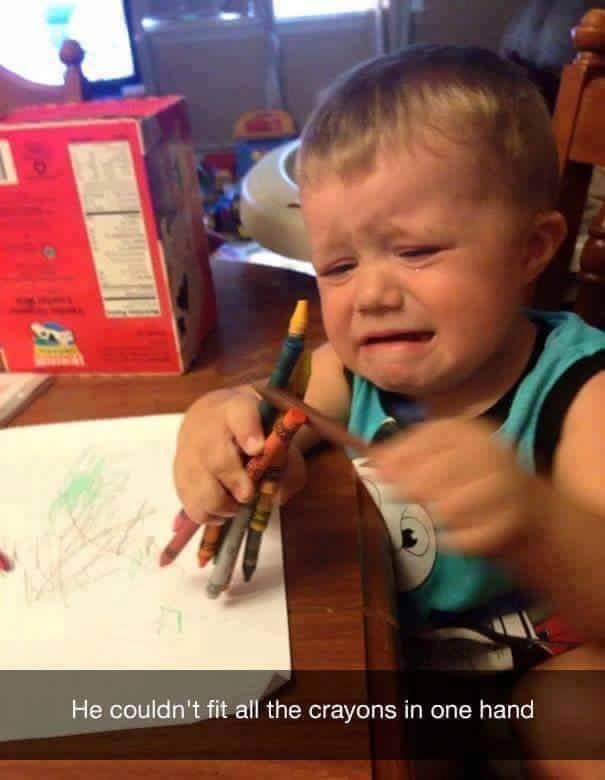 7. The kid's crying because he can't hold all the crayons in one hand. So how does he draw on the paper?