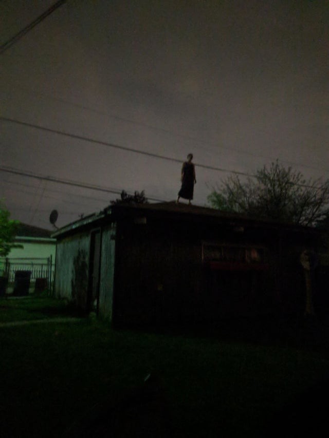 I was walking around the neighborhood when I noticed a woman on the roof of her house ... I ran away immediately!