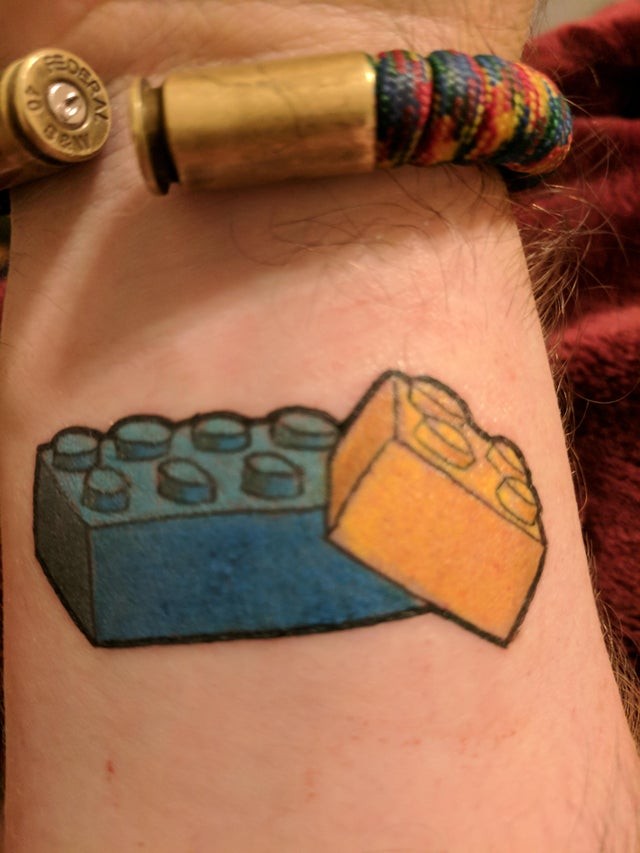 9. This tattoo was chosen by the younger brother and represents the bond with his older brother: the two always played with lego together.