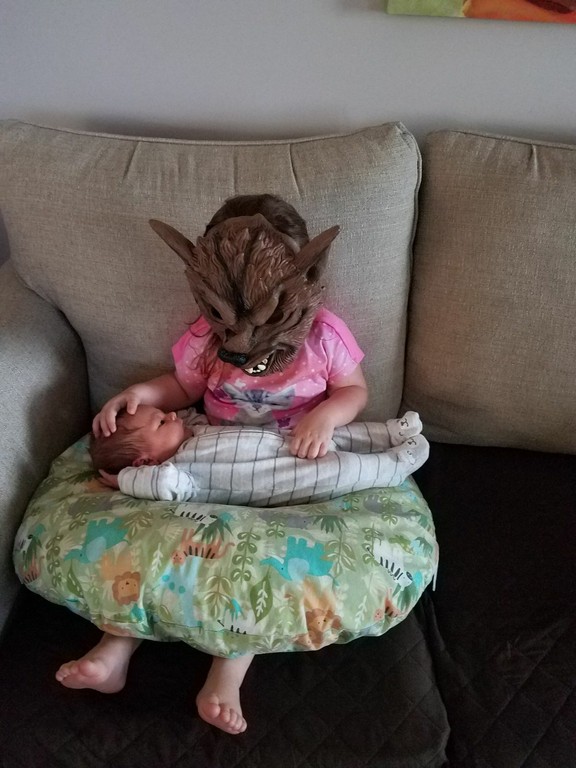 To cuddle her newborn brother, nothing better than dressing up as a big bad wolf!