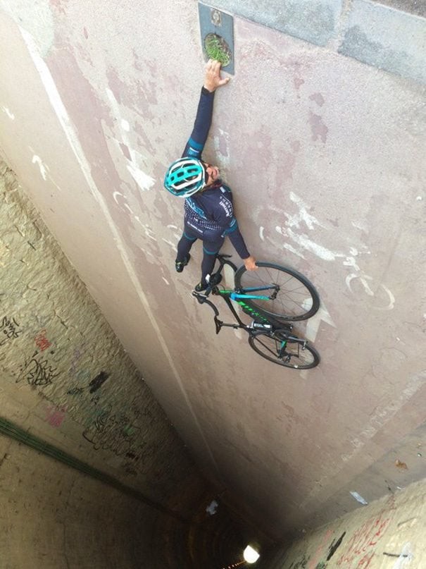 Rather than an acrobatic cyclist, just turn the photograph around to discover why it is such a brilliant illusion!