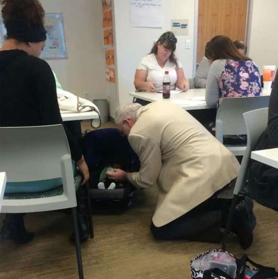 13. The teacher helps a student to give milk to her baby.