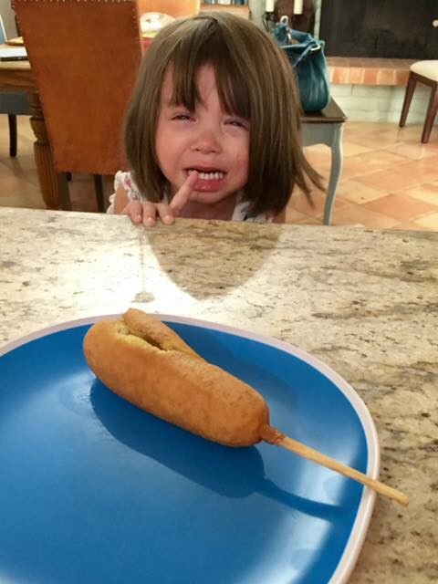 My daughter is crying insistently at the fast food restaurant because her corn dog is split...