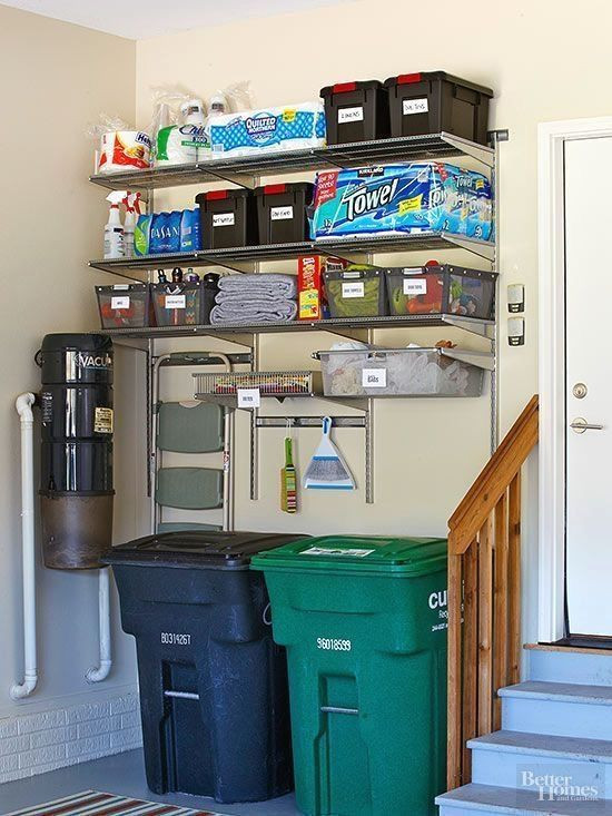 Wall-mounted shelves and recycling bins in a garage