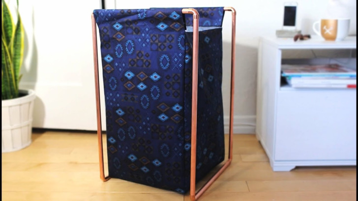 A copper tube frame that supports a large, rectangular fabric bag