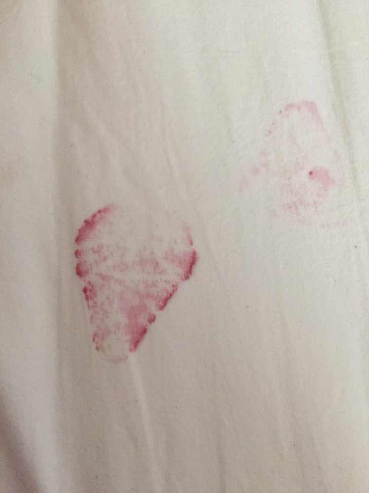 Stain left by a strawberry juice on some white fabric
