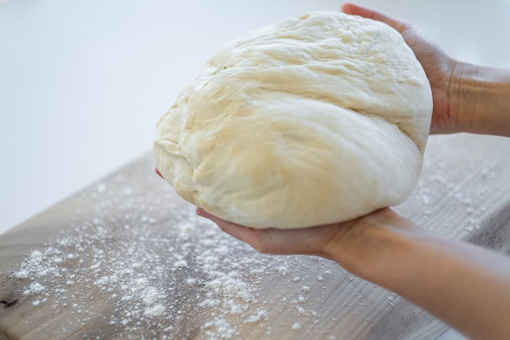 a baker kneading leavened dough by hand