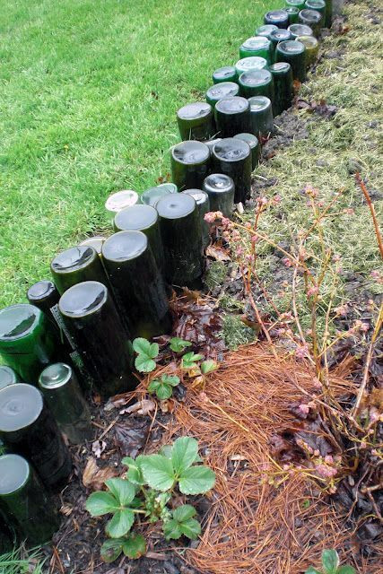 glass bottles, stuck upside down into the ground, serving as a border