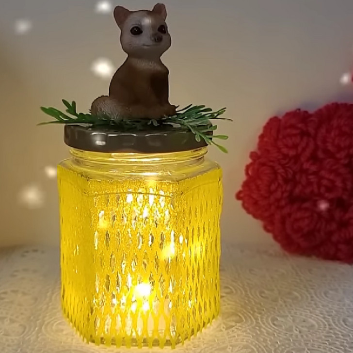 Recycled lamp made from a glass vase and net bag