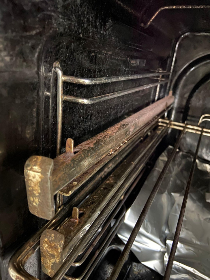 rusty support rails inside a kitchen oven
